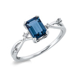 Ring 18 kt WG, 4 Brill. 0,03 ct, TW-si, 1 Topas 1,15 ct Lond. blue